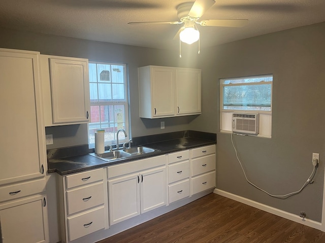 kitchen featuring dark hardwood / wood-style floors, sink, cooling unit, white cabinets, and ceiling fan