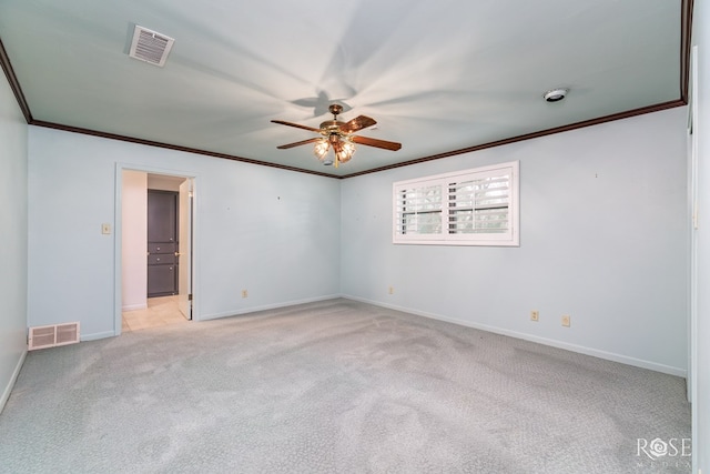 carpeted empty room with ornamental molding and ceiling fan