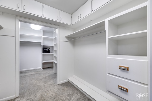 spacious closet featuring light carpet