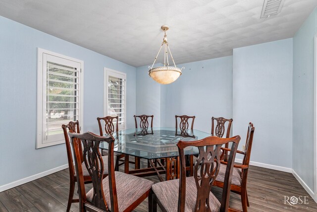 dining room with dark hardwood / wood-style floors