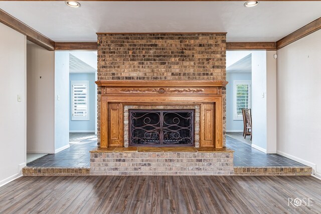 unfurnished living room with dark hardwood / wood-style flooring and a fireplace