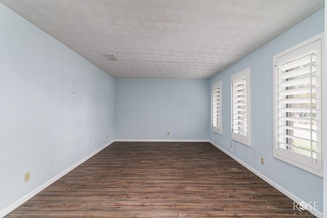 spare room with dark hardwood / wood-style flooring