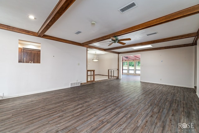 spare room with beamed ceiling, dark hardwood / wood-style floors, and ceiling fan