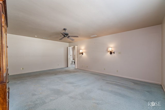 spare room with light carpet and ceiling fan