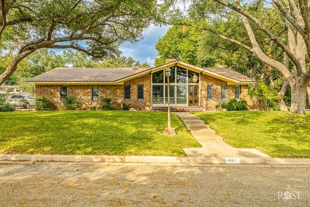 ranch-style home featuring a front yard