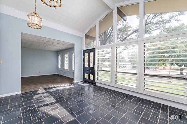 entryway with high vaulted ceiling and a chandelier