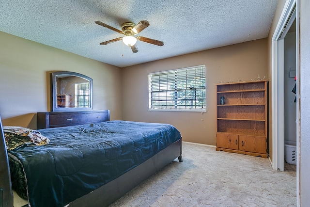 carpeted bedroom featuring a textured ceiling and ceiling fan