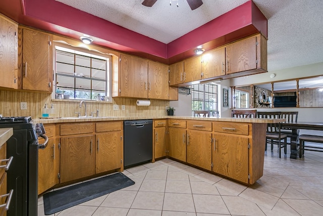 kitchen with light tile patterned flooring, sink, a textured ceiling, kitchen peninsula, and black appliances