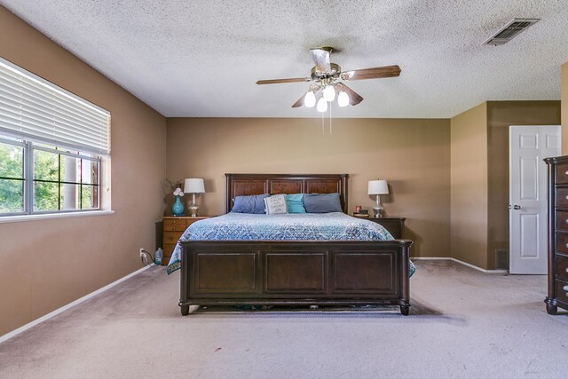 bedroom with light carpet, a textured ceiling, and ceiling fan