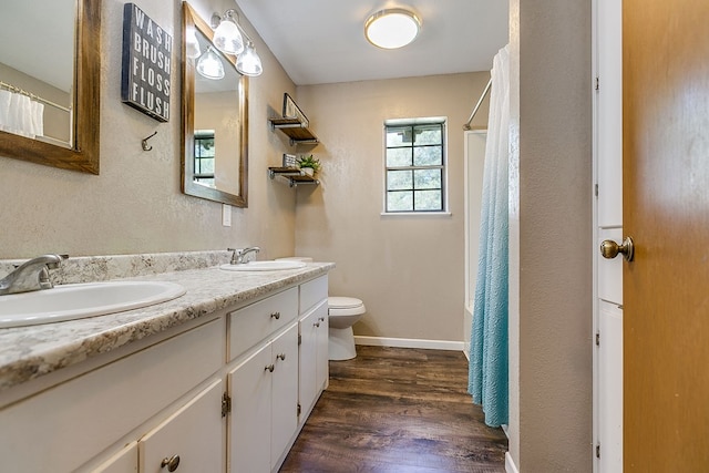 bathroom with hardwood / wood-style flooring, vanity, and toilet