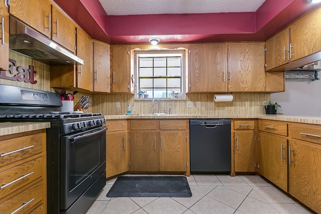 kitchen featuring light tile patterned floors, sink, a textured ceiling, and black appliances