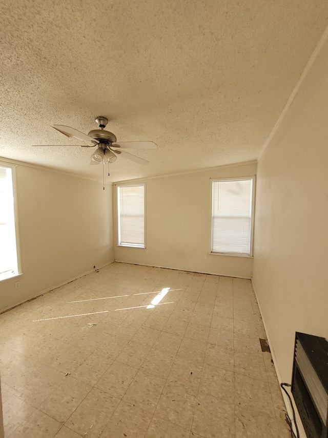 spare room featuring a textured ceiling and ceiling fan