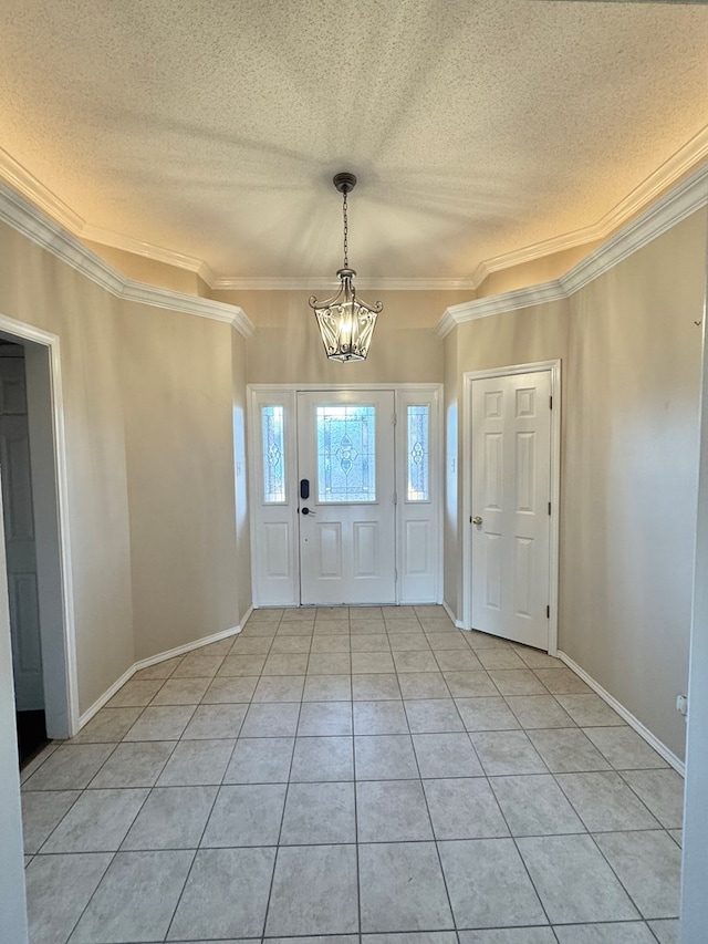 foyer featuring ornamental molding, light tile patterned floors, a textured ceiling, and a chandelier