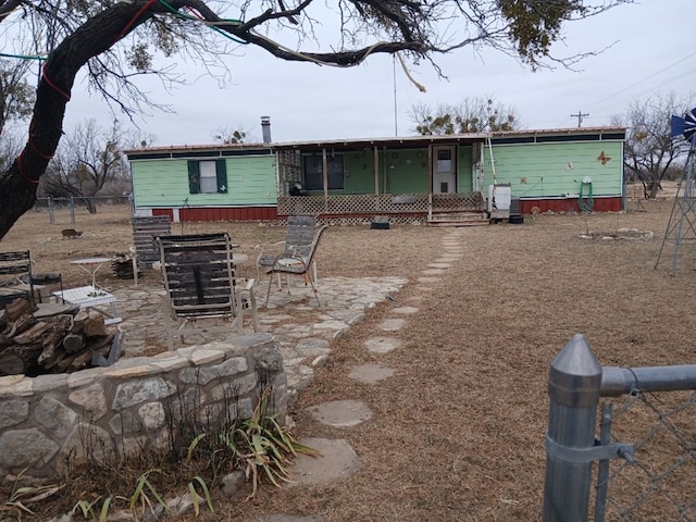 back of property with a patio area and fence