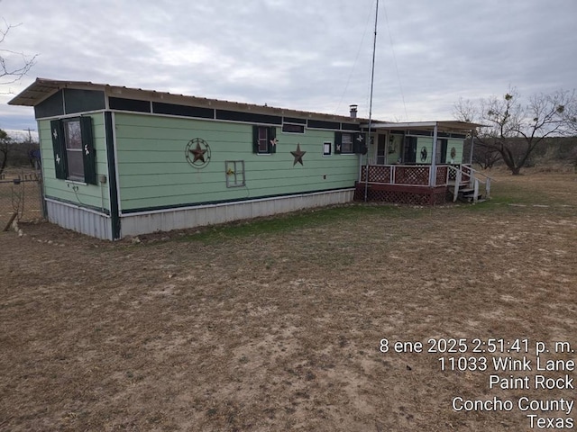 view of side of property with covered porch