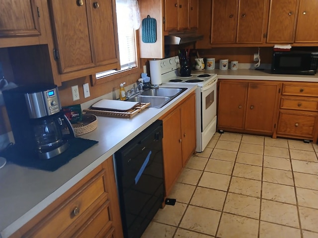 kitchen featuring under cabinet range hood, brown cabinetry, a sink, black appliances, and light countertops