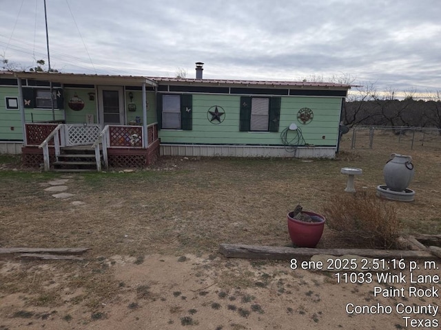 view of front of home with a porch and metal roof