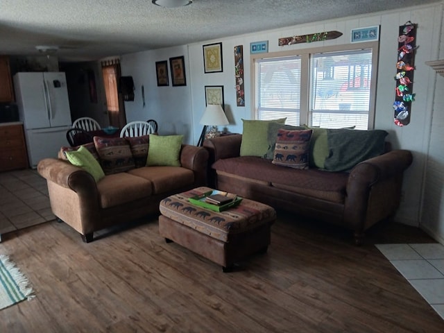 living area with a textured ceiling and wood finished floors
