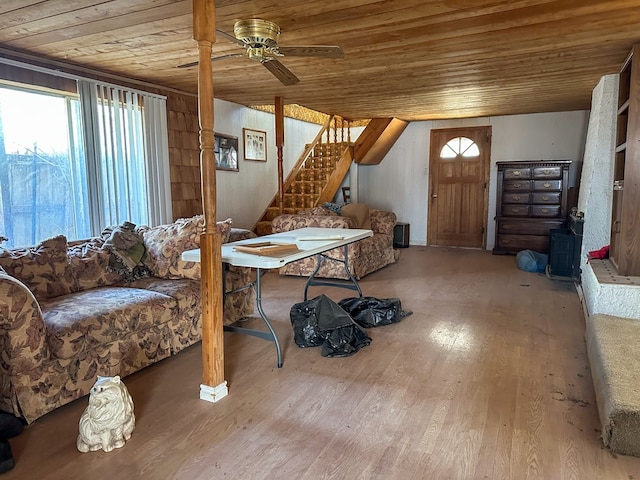 1009 E 6th St, Big Lake, TX 76932 - living room featuring a wood stove, a ceiling fan, wood ceiling, stairway, and wood finished floors