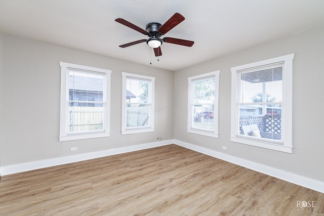 unfurnished room featuring ceiling fan, baseboards, and wood finished floors