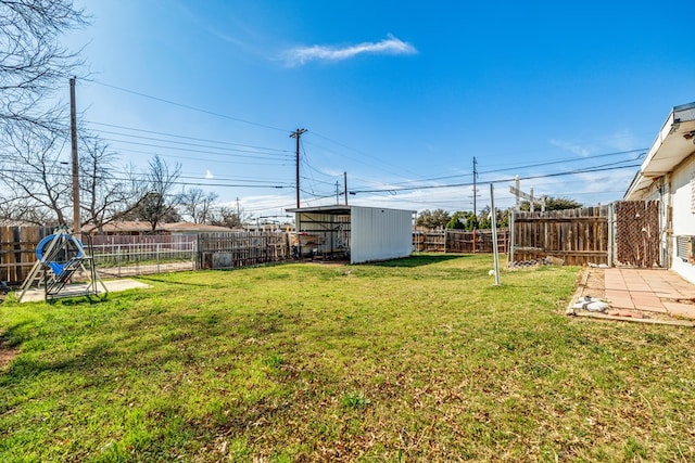 view of yard featuring a fenced backyard and an outbuilding