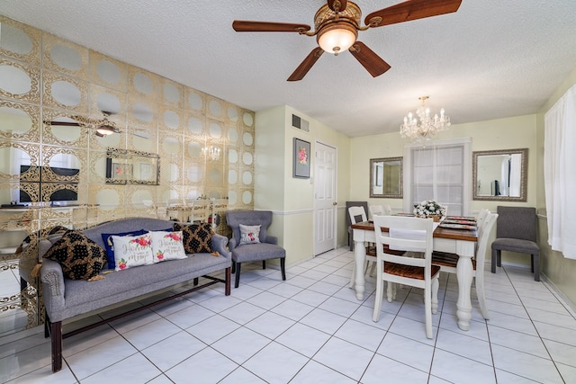 dining room with wallpapered walls, visible vents, a textured ceiling, and light tile patterned flooring