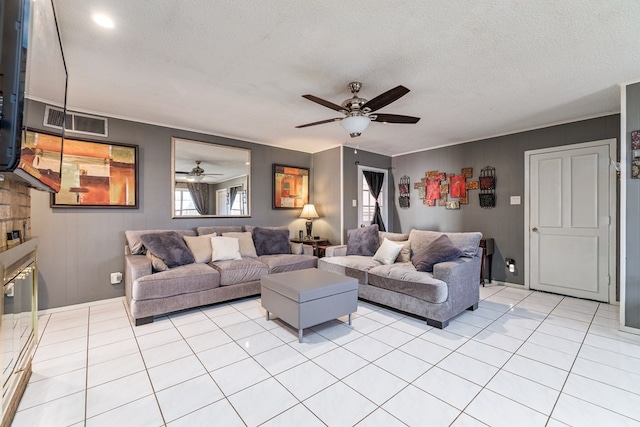 living room featuring visible vents, ceiling fan, a textured ceiling, and light tile patterned floors