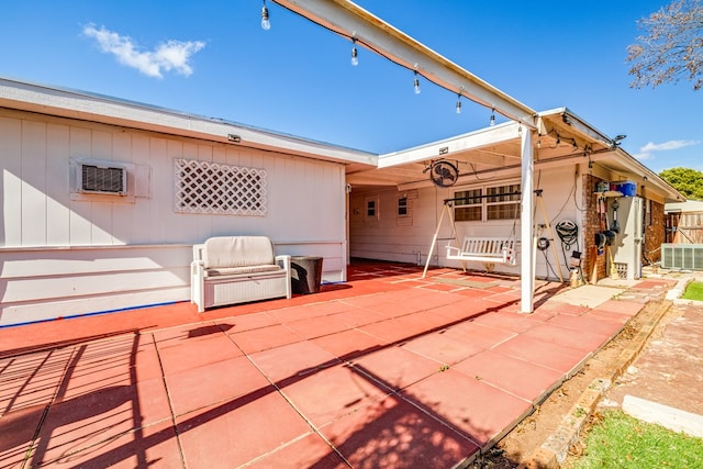 view of patio / terrace featuring central AC unit and an AC wall unit