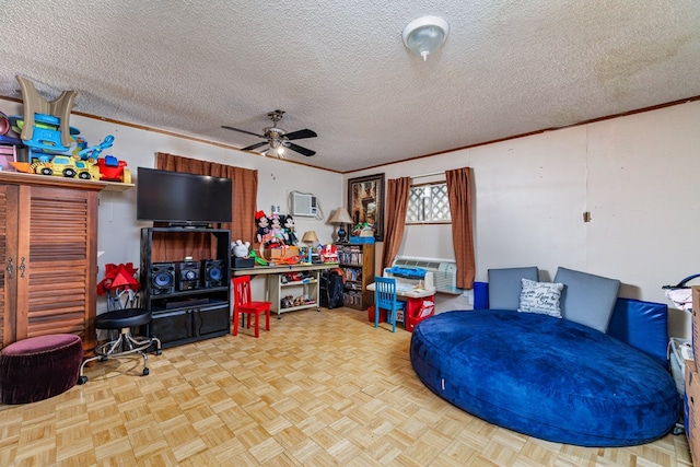 interior space with ceiling fan, ornamental molding, and a textured ceiling