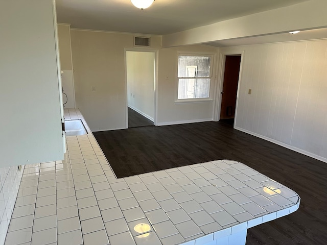 spare room featuring wood-type flooring and sink