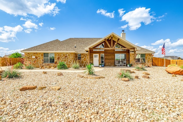 5292 Grey Wolf Ln, San Angelo, TX 76901 - rear view of property with stone siding, a chimney, roof with shingles, and a patio area