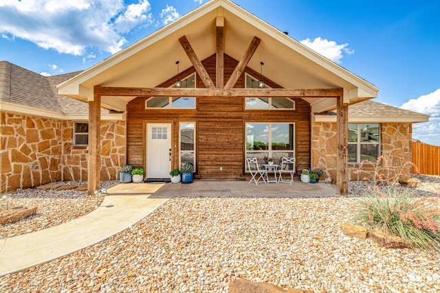 5292 Grey Wolf Ln, San Angelo, TX 76901 - back of house with stone siding, a patio, and roof with shingles