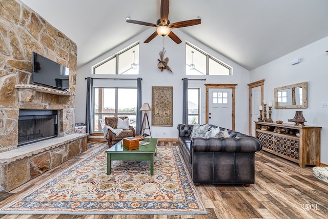 5292 Grey Wolf Ln, San Angelo, TX 76901 - living room with wood finished floors, a ceiling fan, a stone fireplace, healthy amount of natural light, and high vaulted ceiling