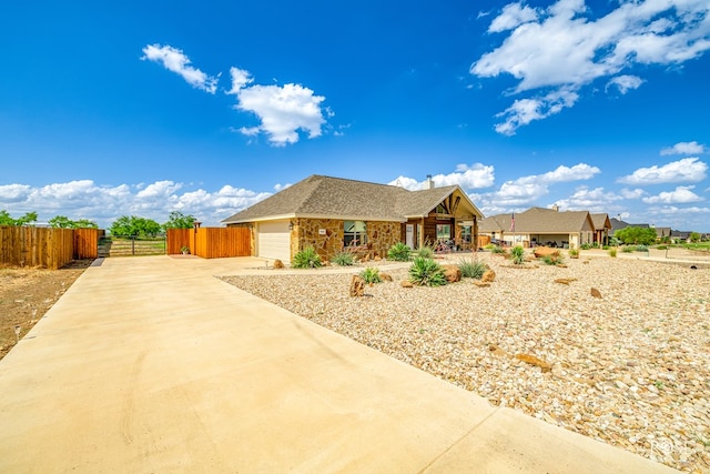 5292 Grey Wolf Ln, San Angelo, TX 76901 - view of front of property featuring driveway, an attached garage, stone siding, and a porch