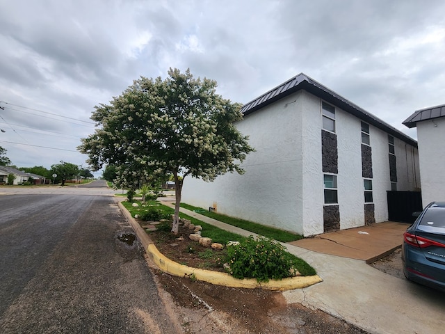 1901 Pulliam St, San Angelo, TX 76905 - view of home's exterior featuring stucco siding and stone siding