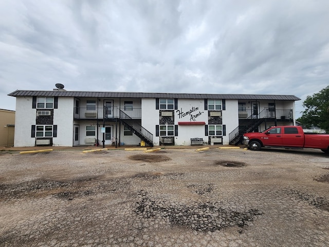 1901 Pulliam St, San Angelo, TX 76905 - view of property with stairway, uncovered parking, and cooling unit
