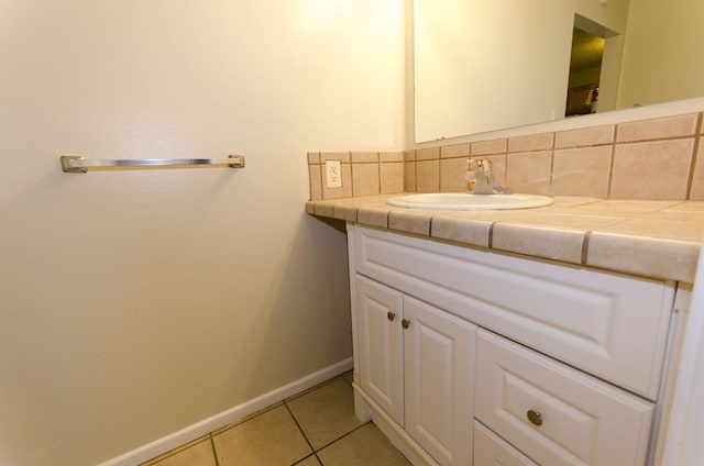 1901 Pulliam St, San Angelo, TX 76905 - bathroom with vanity, tile patterned flooring, baseboards, and tasteful backsplash