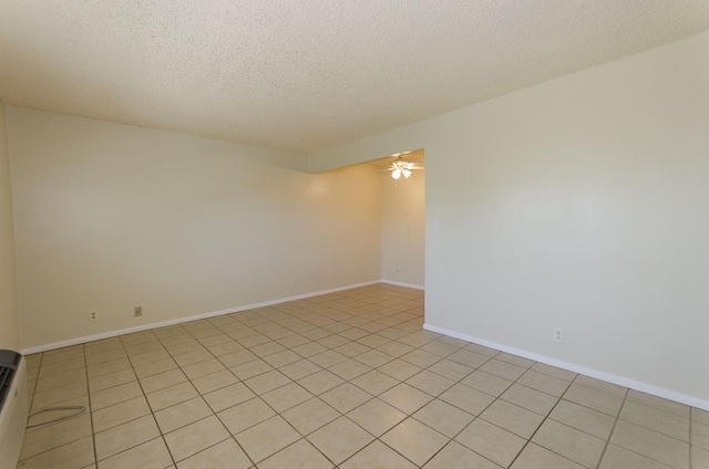 1901 Pulliam St, San Angelo, TX 76905 - empty room with a textured ceiling, ceiling fan, baseboards, and light tile patterned flooring