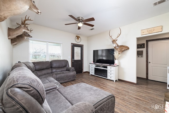 living room with ceiling fan, wood finished floors, visible vents, and baseboards