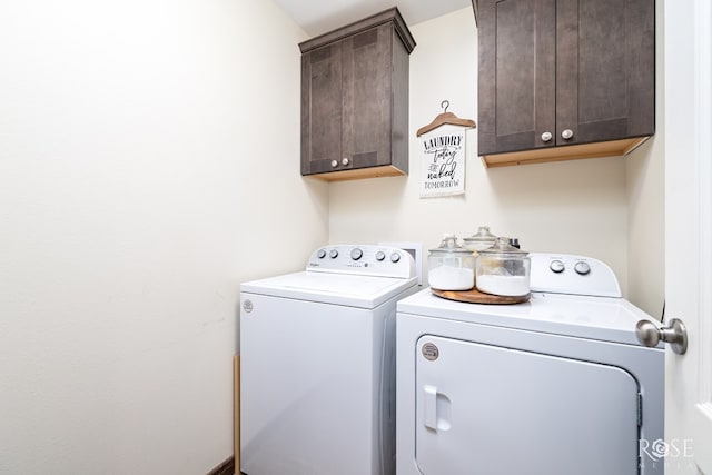 washroom with cabinet space and separate washer and dryer