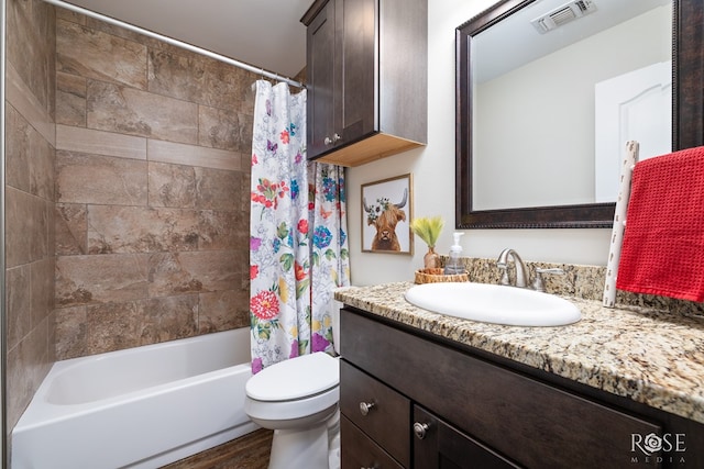 full bathroom with toilet, shower / tub combo, wood finished floors, vanity, and visible vents