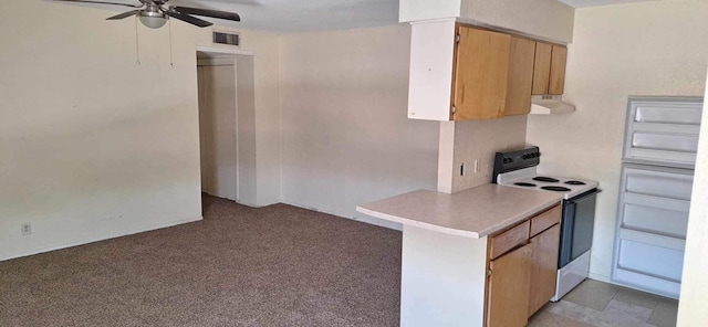 kitchen featuring electric stove, ceiling fan, and light colored carpet