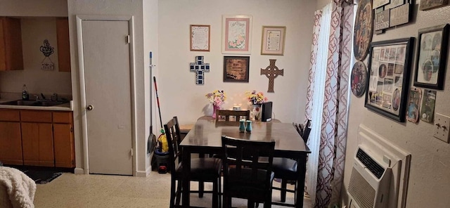 dining area with sink and a wall unit AC