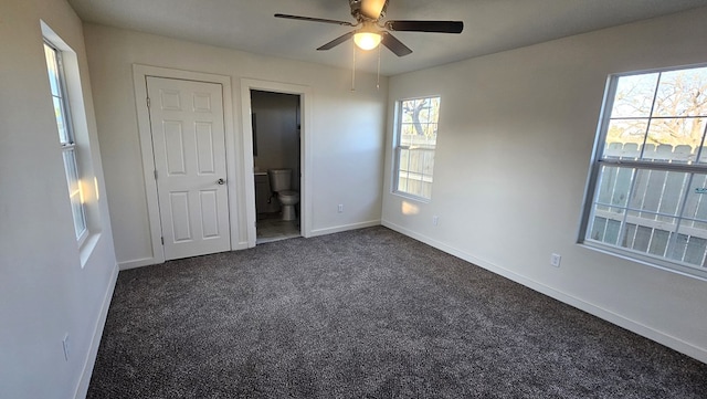 1730 La Follette St, San Angelo, TX 76905 - unfurnished bedroom featuring dark carpet, baseboards, ensuite bathroom, and a ceiling fan