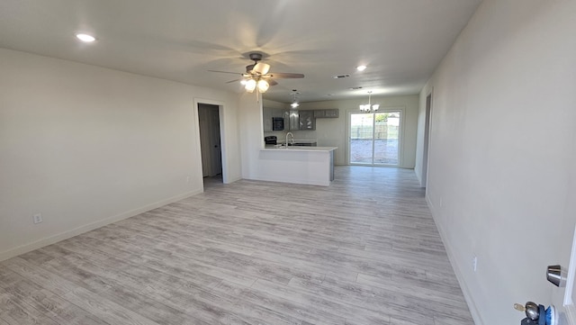 1730 La Follette St, San Angelo, TX 76905 - unfurnished living room with a chandelier, ceiling fan, a sink, baseboards, and light wood finished floors