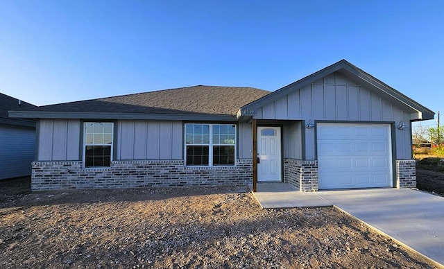 1730 La Follette St, San Angelo, TX 76905 - ranch-style home featuring brick siding, board and batten siding, driveway, and a garage