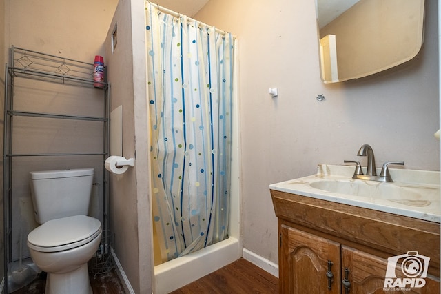 bathroom with walk in shower, vanity, toilet, and wood-type flooring