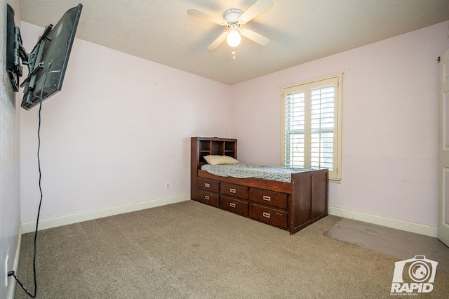 carpeted bedroom with a textured ceiling and ceiling fan