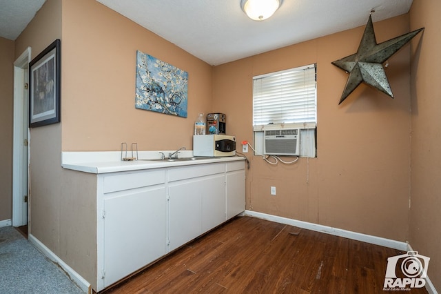 kitchen featuring white cabinetry, cooling unit, sink, and dark hardwood / wood-style floors