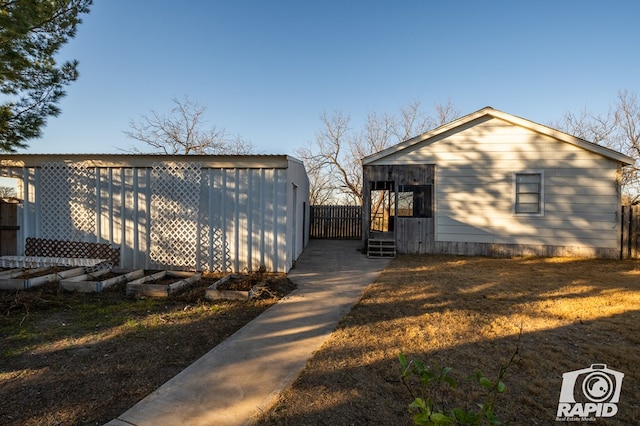 view of property exterior featuring a yard and an outbuilding